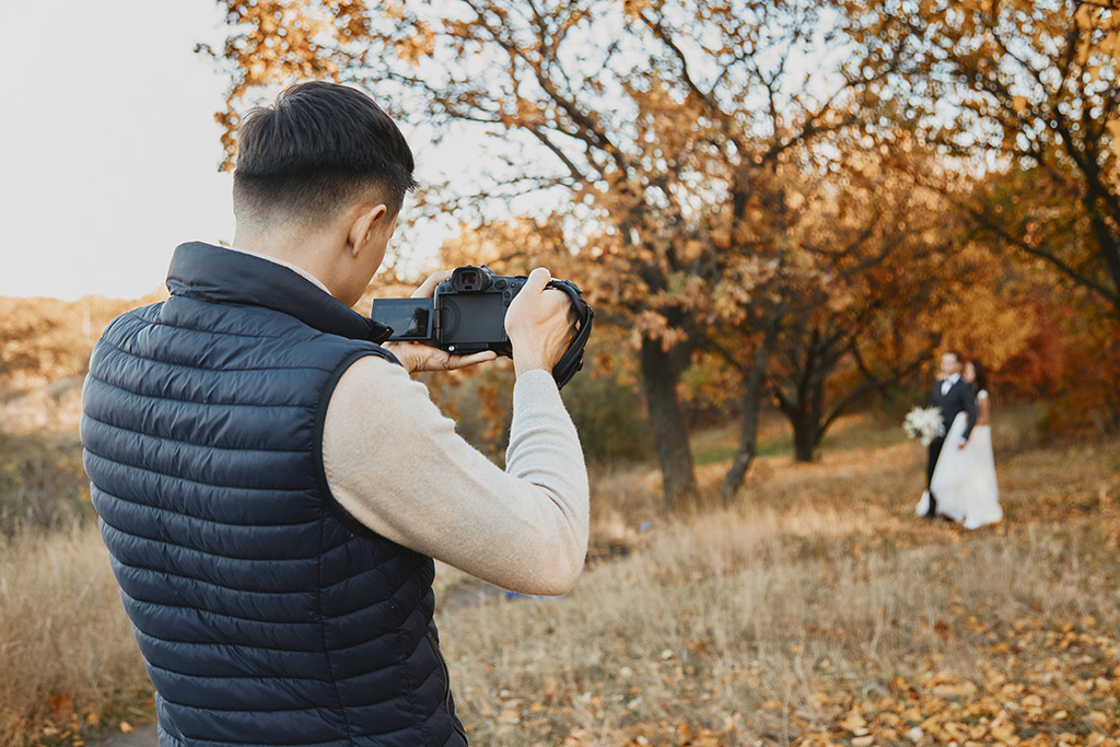 wedding photographer taking pictures of the bride and groom